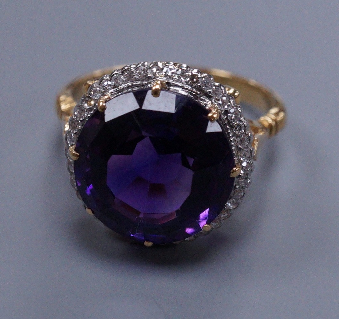 An 18ct gold and platinum, amethyst and diamond circular cluster ring, size M, gross 5.7 grams